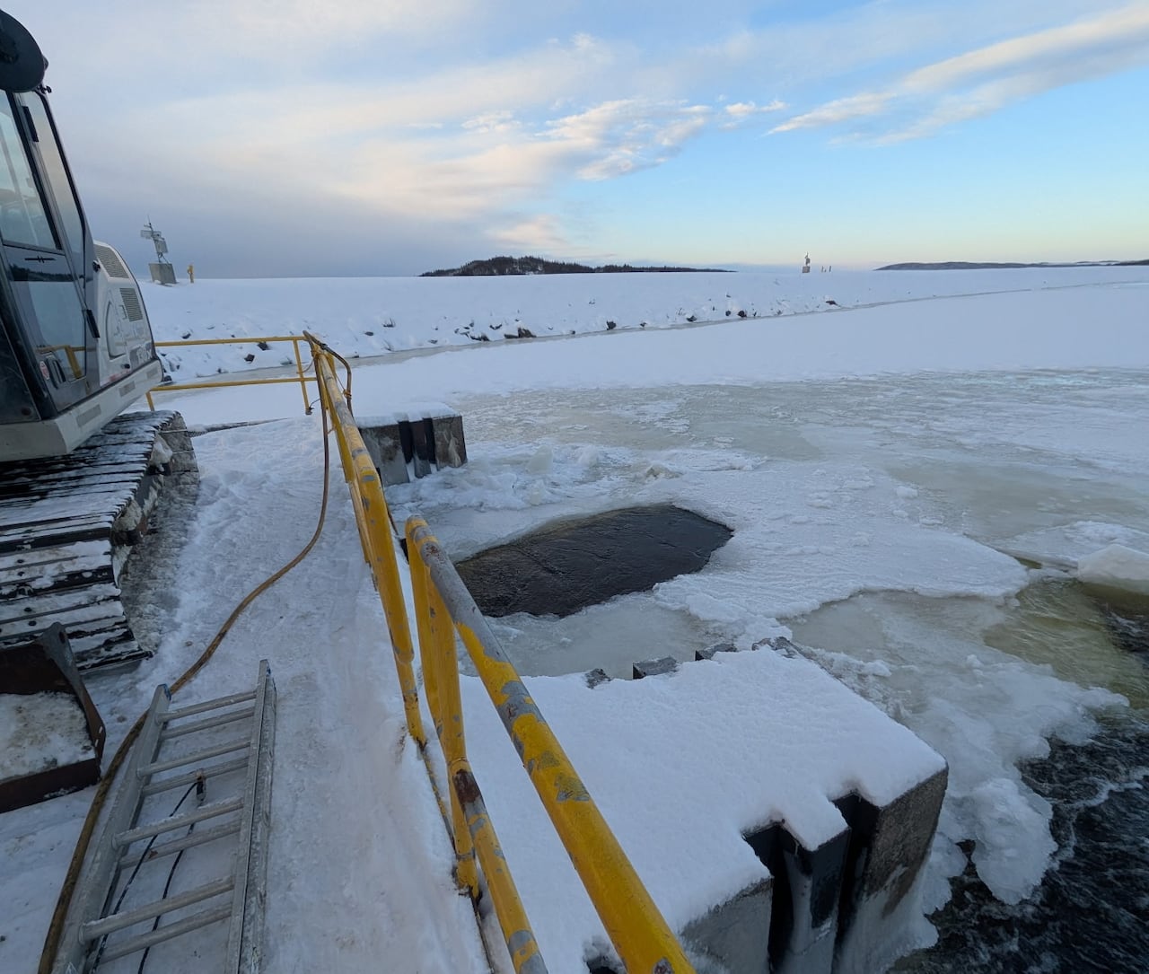 Yellow railing and icy body of water
