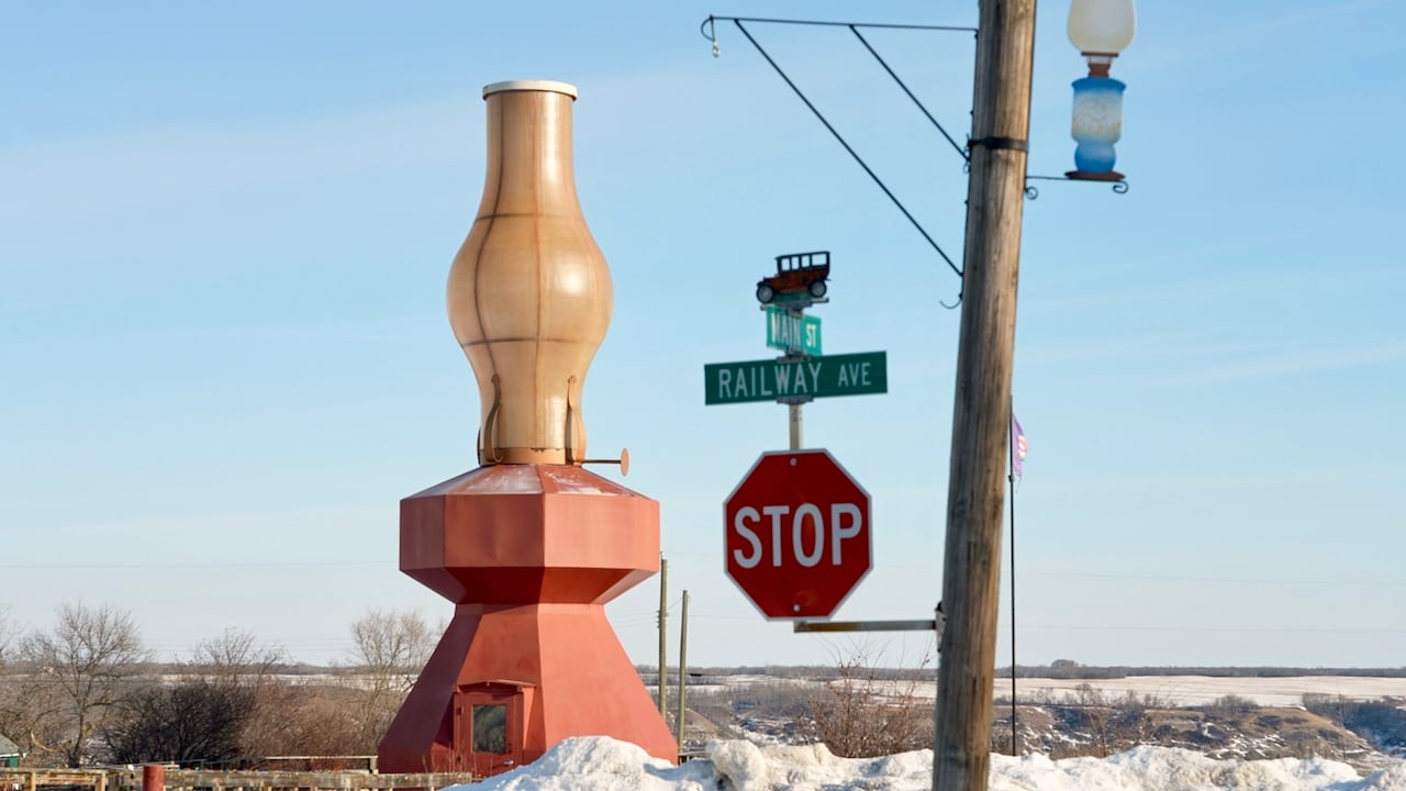 A giant lamp structure behind a light pole.