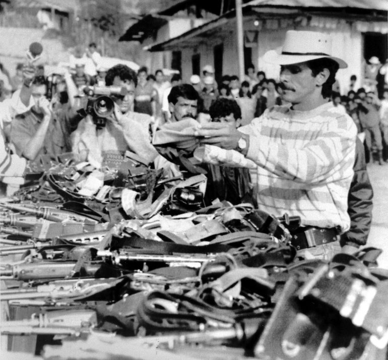 Columbia presidential candidate Carlos Pizarro, of the M-19 guerrilla movement, surrenders his gun in Bogota March 1990. Pizarro died on April 26, 1990 in a hospital, after being shot in the head by a gunman during a commercial flight. Pizarro, 39, was the third candidate in the May 27 elections to be assassinated. (COLOMBIA) REUTERS/Zoraida Diaz /Landov