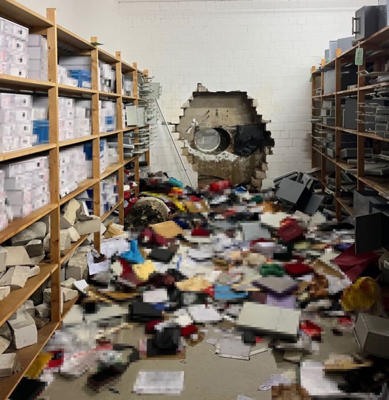 This handout photo taken on December 29, 2025 in Gelsenkirchen, western Germany, and handed out by the Police Gelsenkirchen shows a giant hole in a wall of the bank vault of a Sparkasse bank branch after the unknown perpetrator(s) broke in during the Christmas holidays.