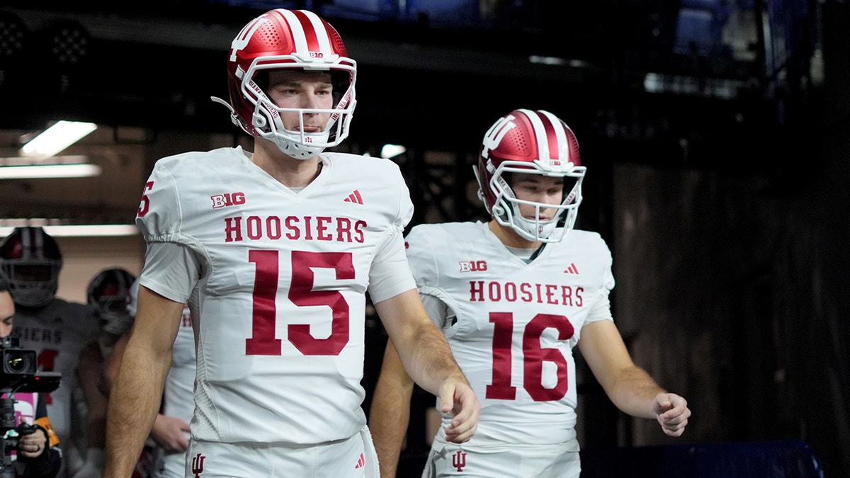 Fernando and Alberto Mendoza are dressed in their Indiana Hoosiers football uniforms before a game.