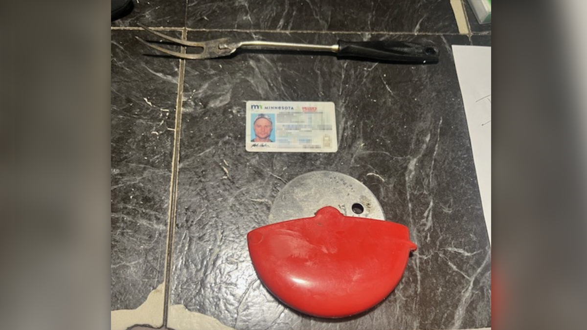 The BBQ fork and pizza cutter along with a Minnesota driver's license.
