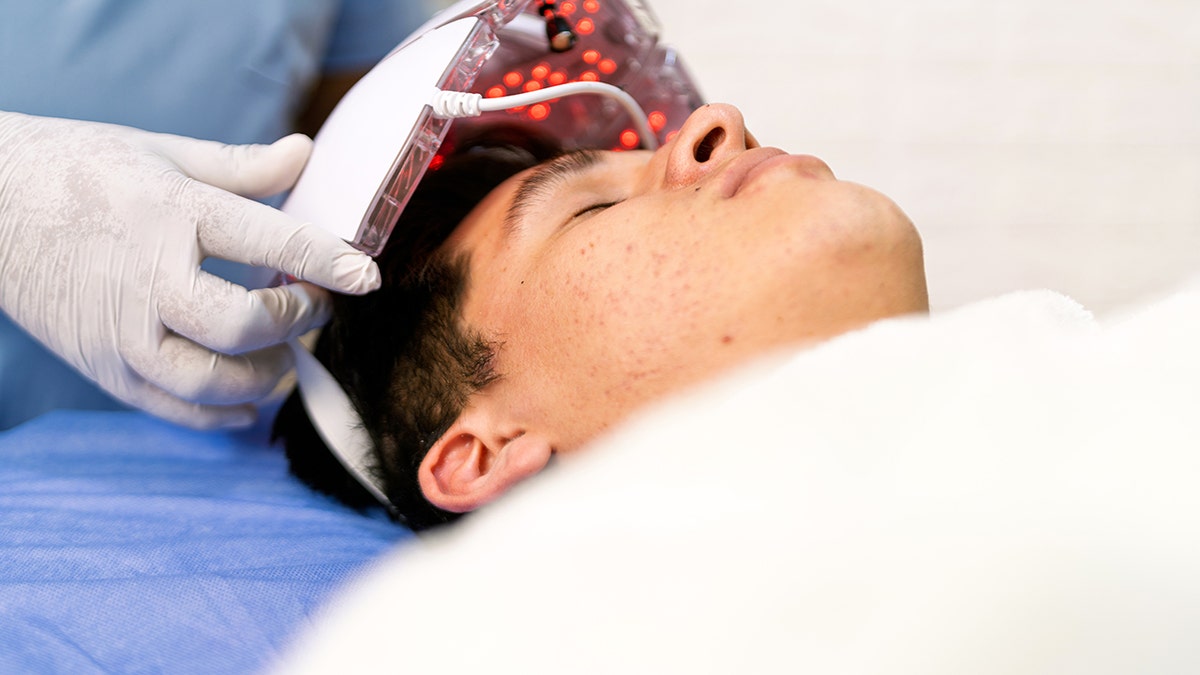 Young man undergoing led light therapy