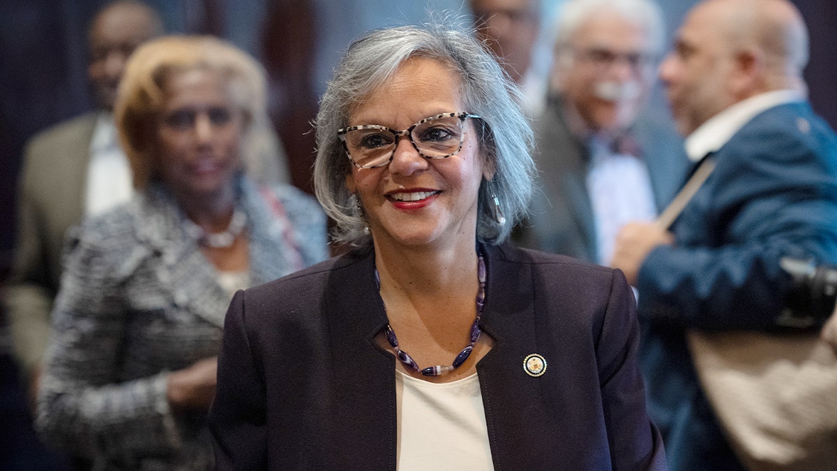 A Democratic member of Congress walks ahead of a policy speech to a civic audience in Chicago.
