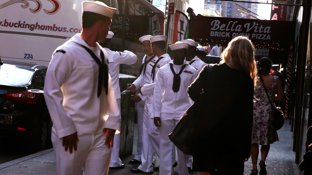 Navy Sailor looking at woman