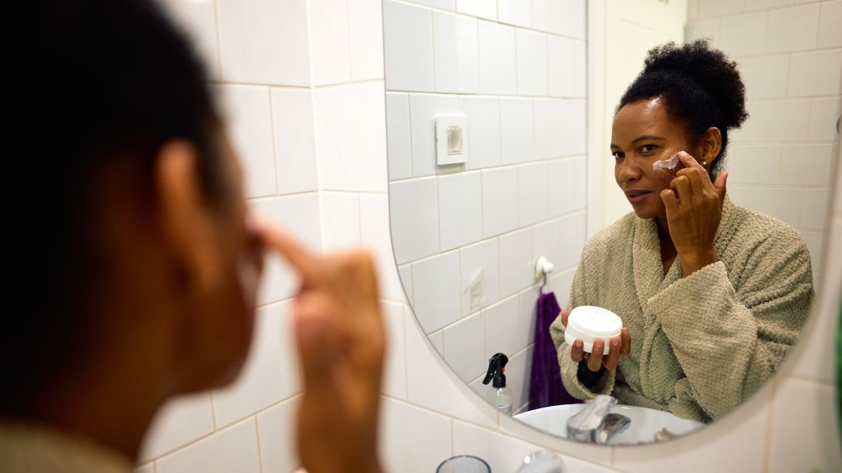 Woman applying face cream