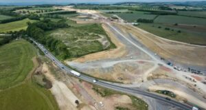 Man killed and woman & 2 children injured after crash with car transporter