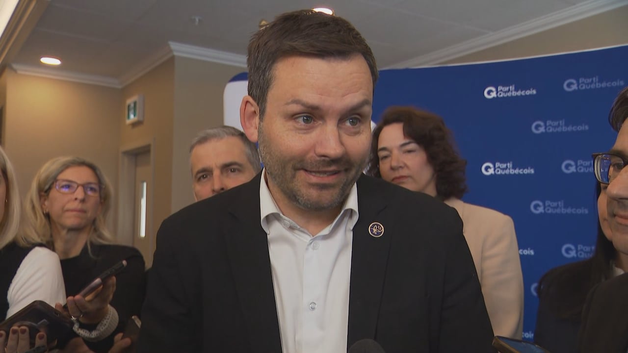 PQ leader Paul St-Pierre Plamondon, smiling, speaks to reporters