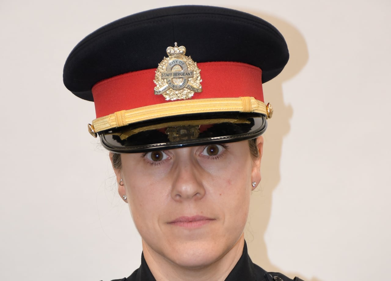 A portrait of a female police officer in uniform.