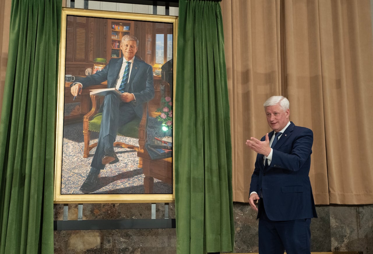 Former prime minister Stephen Harper gestures to the artist after he unveiled his official portrait during a ceremony in Ottawa, on Tuesday, Feb 3, 2026.