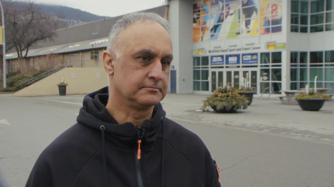 Man standing in front of hockey arena
