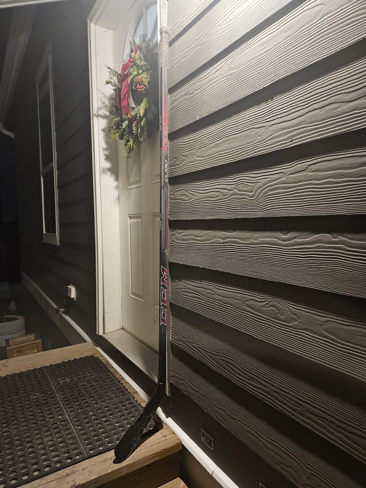 Hockey stick in front of door frame 