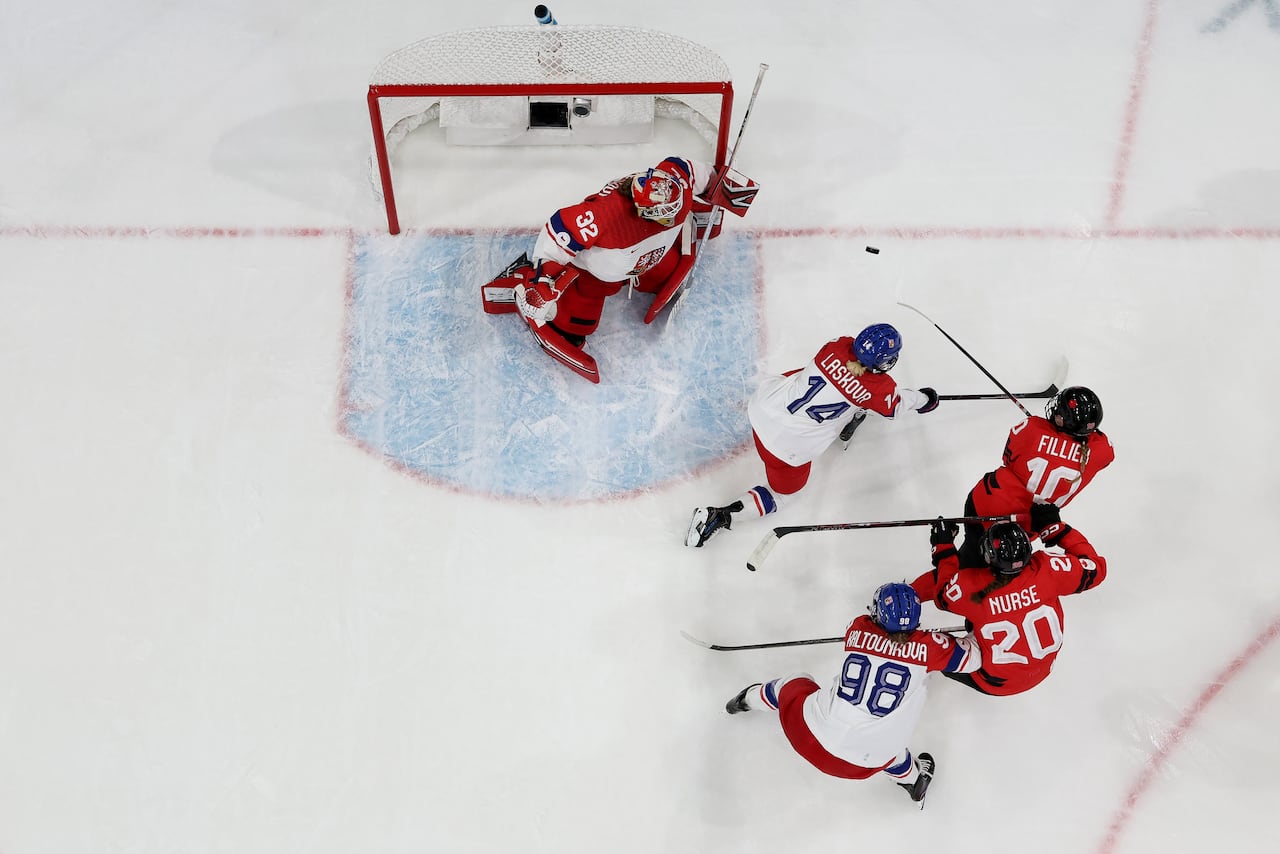 A hockey player scores.