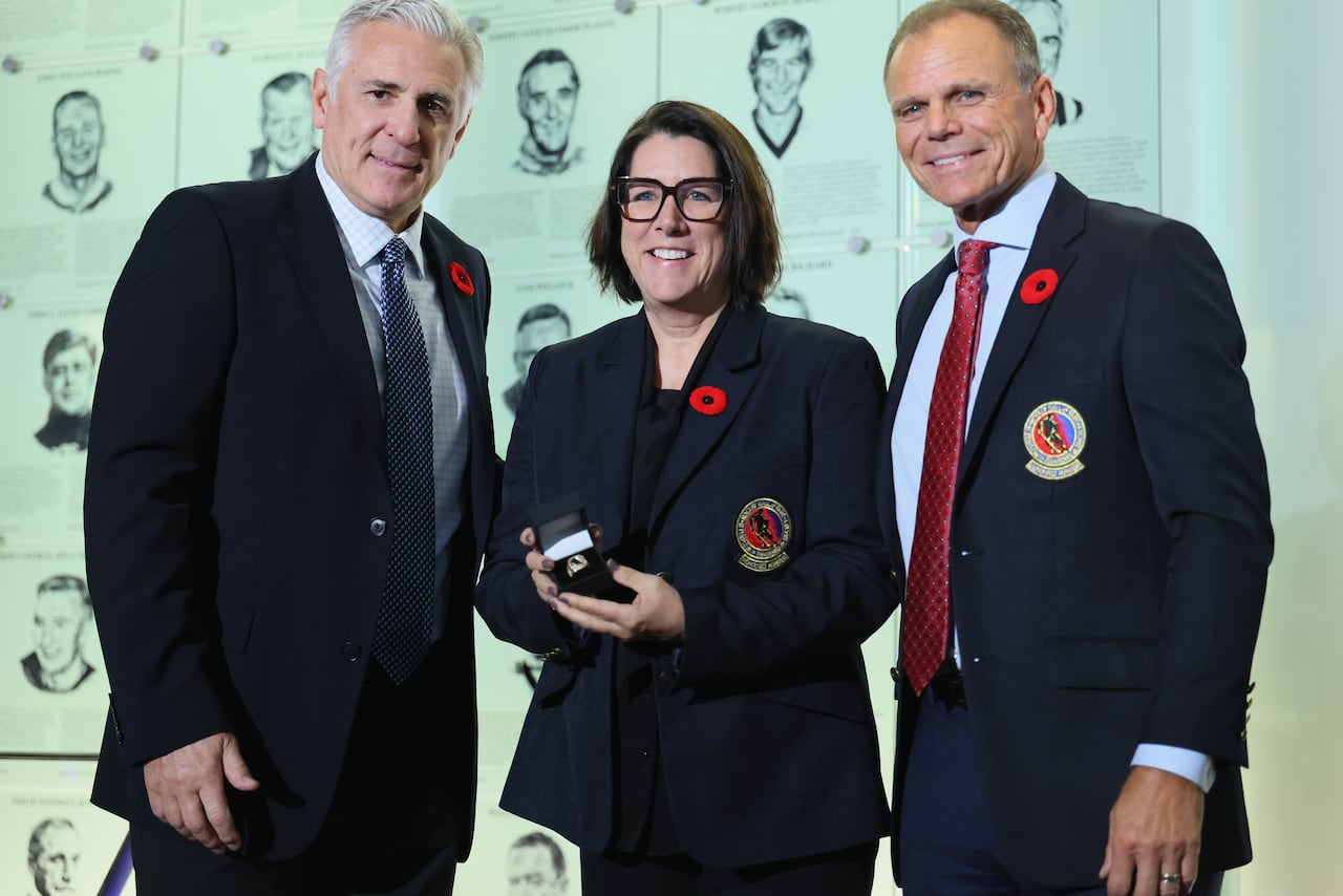 Three people at a ceremony.