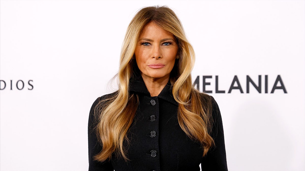 Melania Trump poses for photographs while attending a formal premiere event.