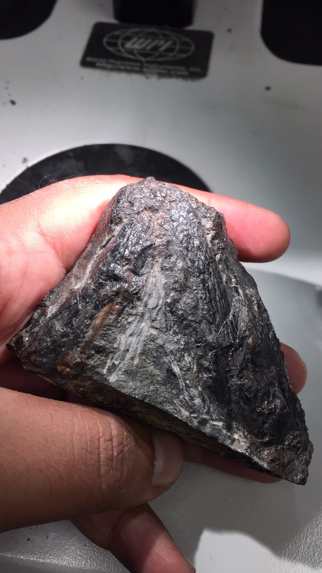 Hand holding triangular shaped rock