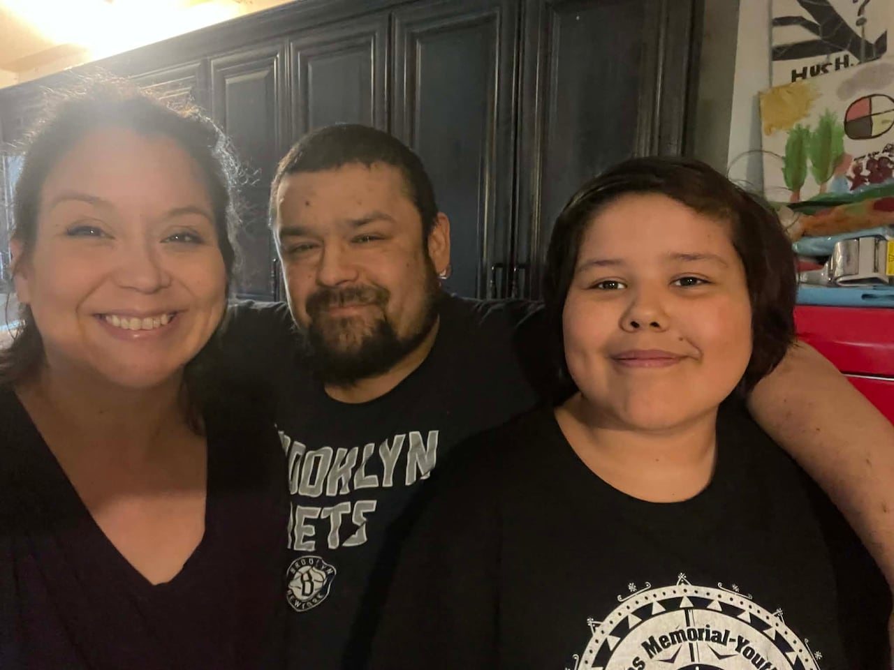 a woman and a man and a child smiling