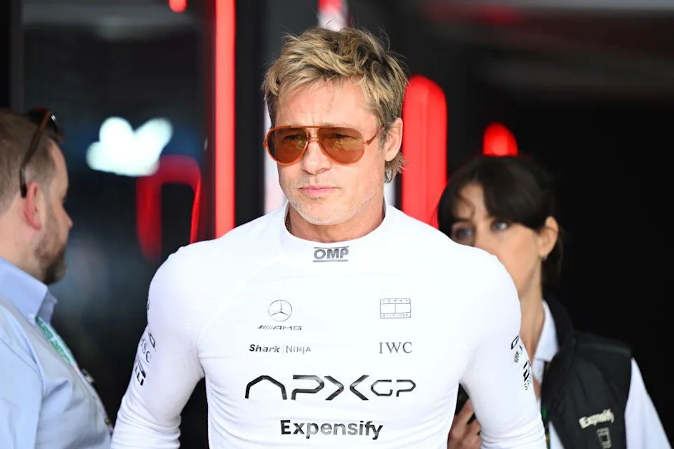 Picture of Brad Pitt in a white racing suit wearing sunglasses.