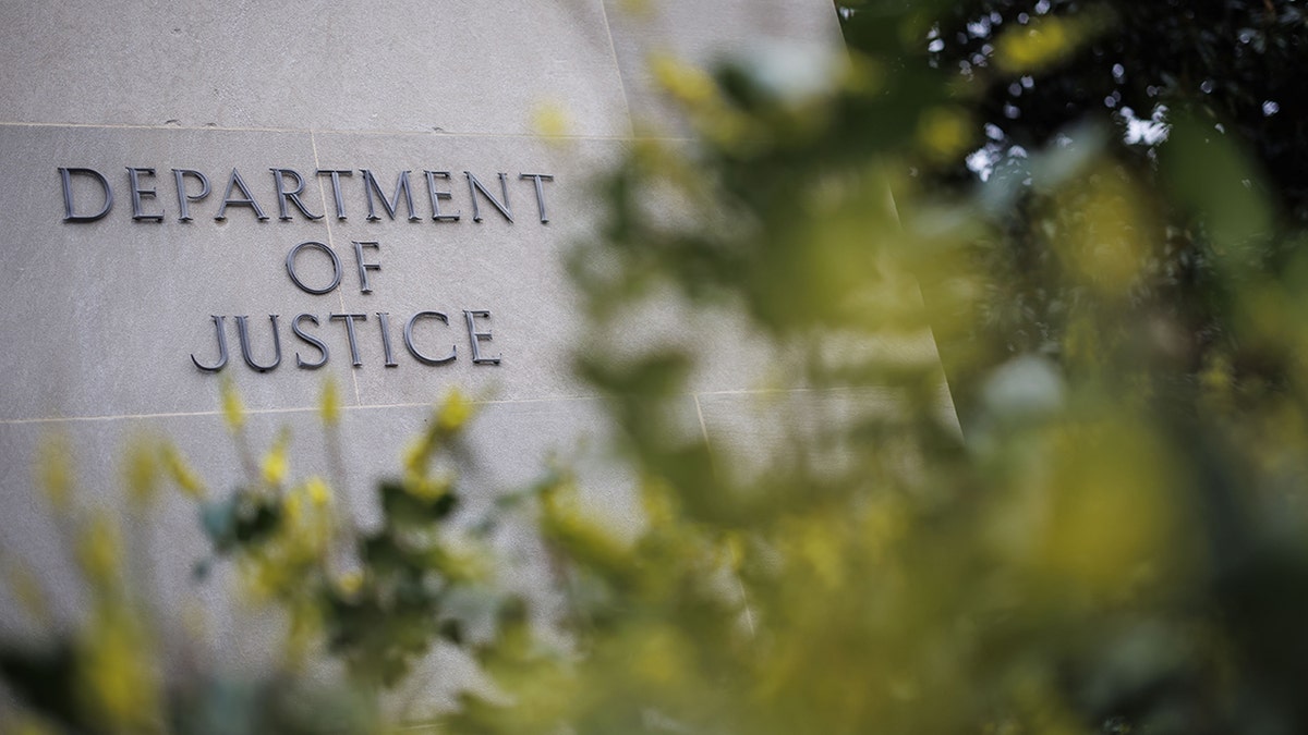 Justice Department sign outside building.