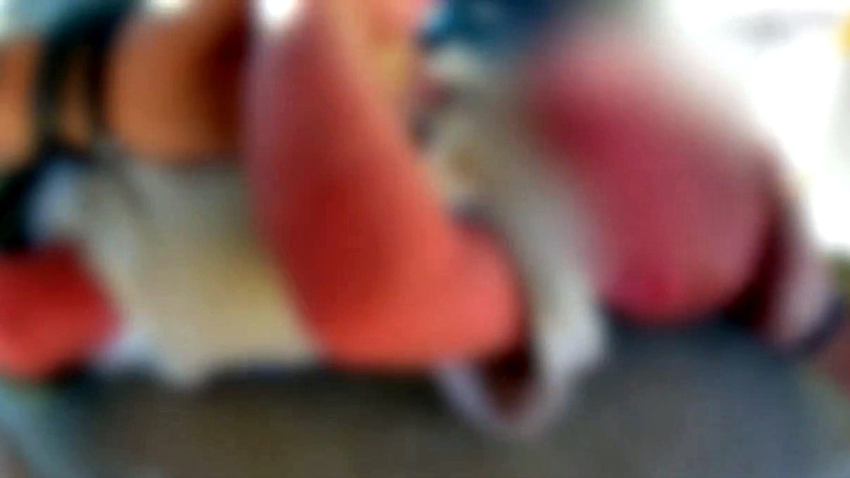 deputy performing life-saving measures on infant