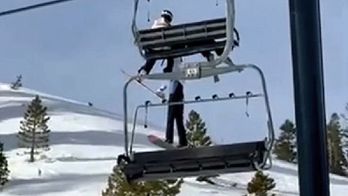 Girl dangles from ski lift high above snowy slope at California resort