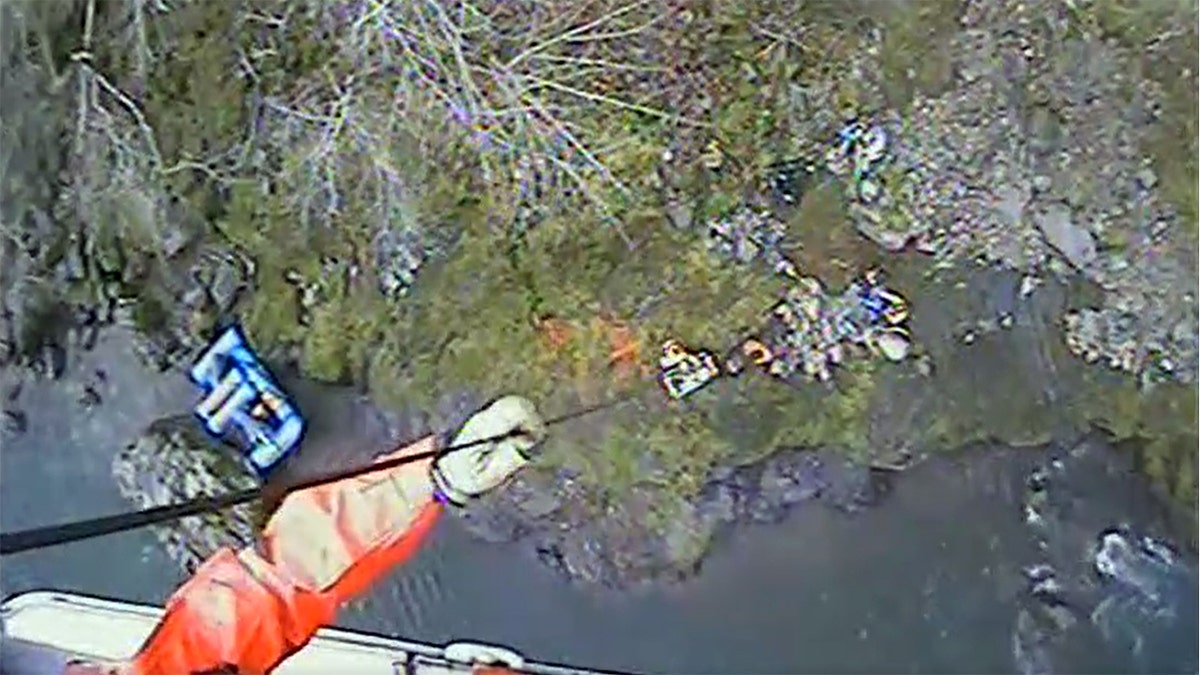 Coast Guard helicopter hoisting Gabriel Vaughn to safety