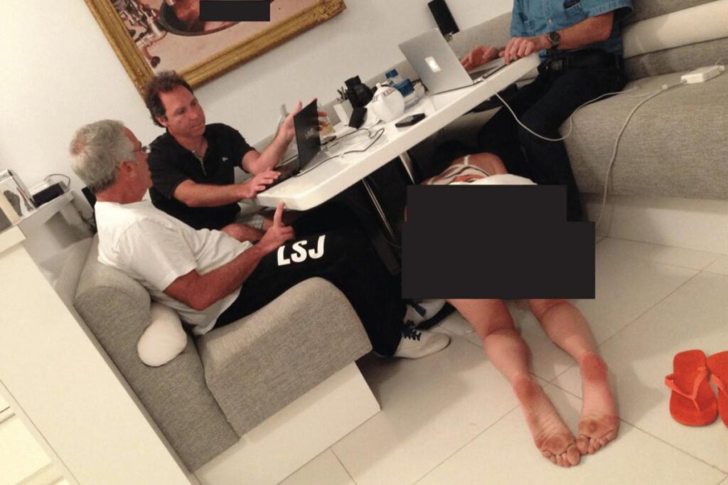 Disturbing photo shows Epstein, pals sitting unfazed as bikini woman crawls under table by naked baby picture