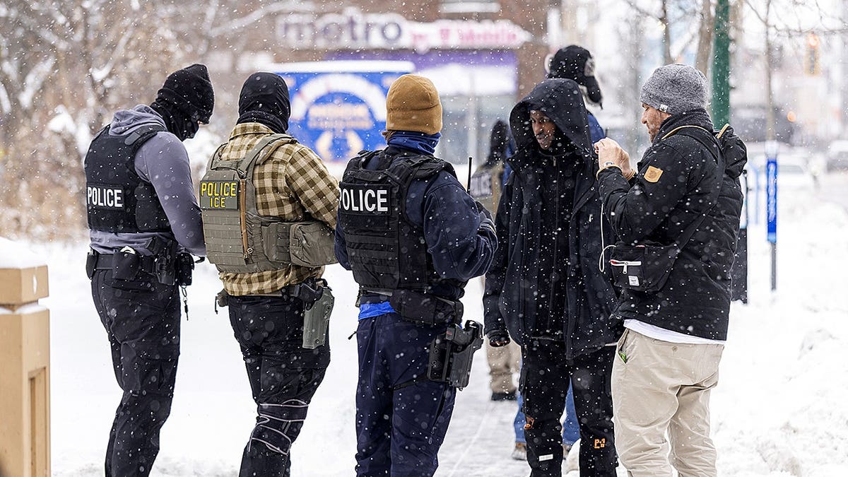 ICE agents stand outside in the cold in Minnesota.