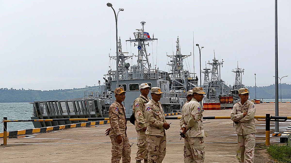 Sailors stand guard near petrol boats at the Cambodian Ream Naval Base in Sihanoukville, Cambodia, July 26, 2019. 