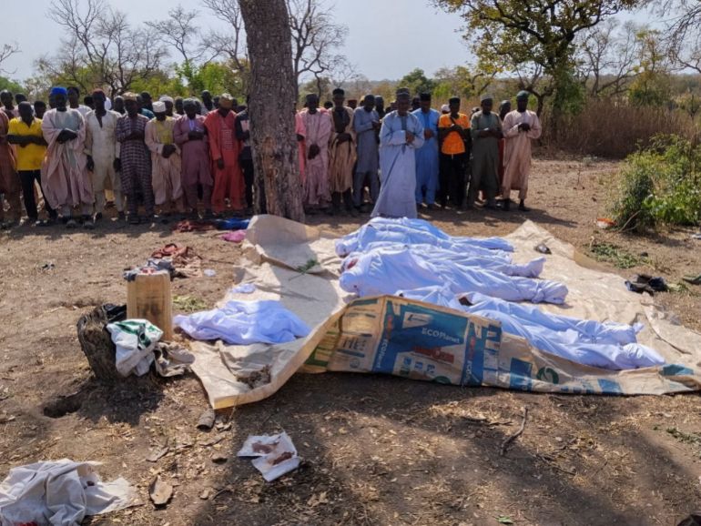 People pray beside the bodies of victims of a terror attack before their burial at Woro community, after an overnight attack by gunmen that killed dozens of residents, in Kaiama Local Government Area of Kwara State, Nigeria, February 4, 2026. REUTERS/Oluseyi Dasilva TPX IMAGES OF THE DAY