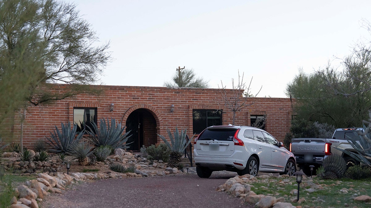The front exterior of Nancy Guthrie's house including the entryway and surrounding landscaping.