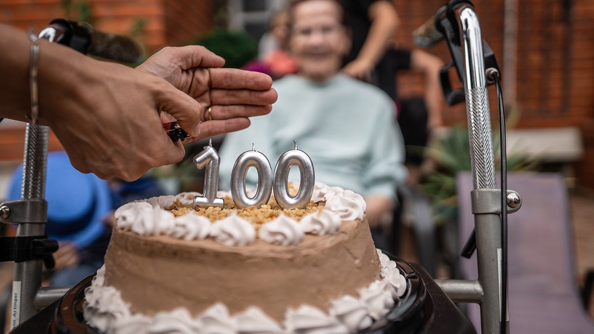 Surprise grandmother's birthday party with family in front yard