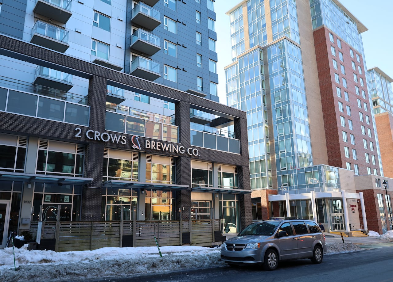 A brewery is shown from outside on a February day, with snowbanks visible.