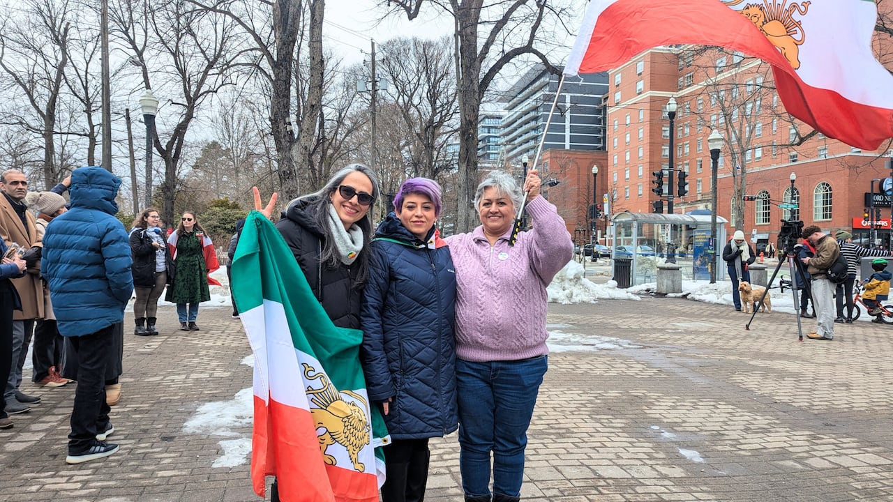 Three women hugging in an Iranian protest in Halifax.