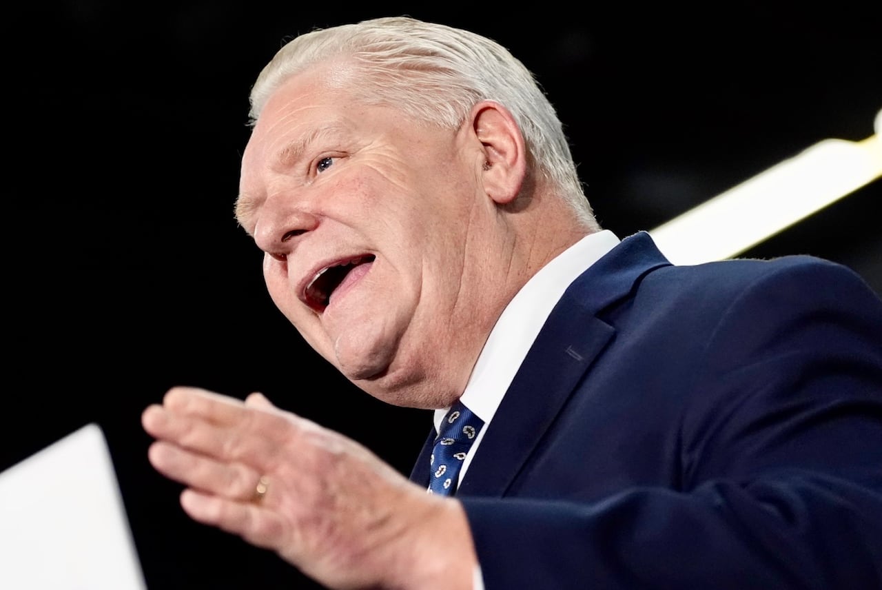 A man gestures with his hand while speaking.