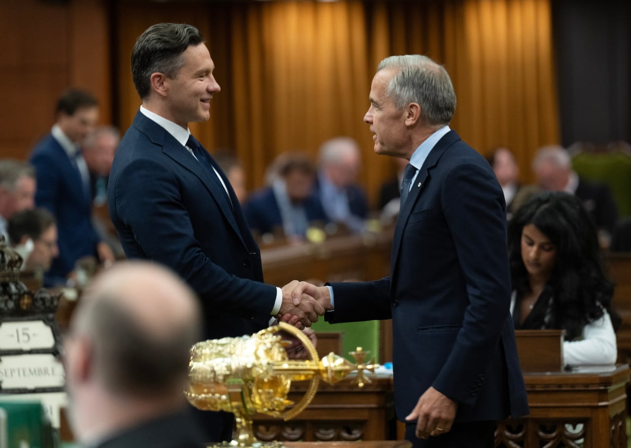 Leader of the Conservative Party Pierre Poilievre, left, shakes hands with Prime Minister Mark Carney 
