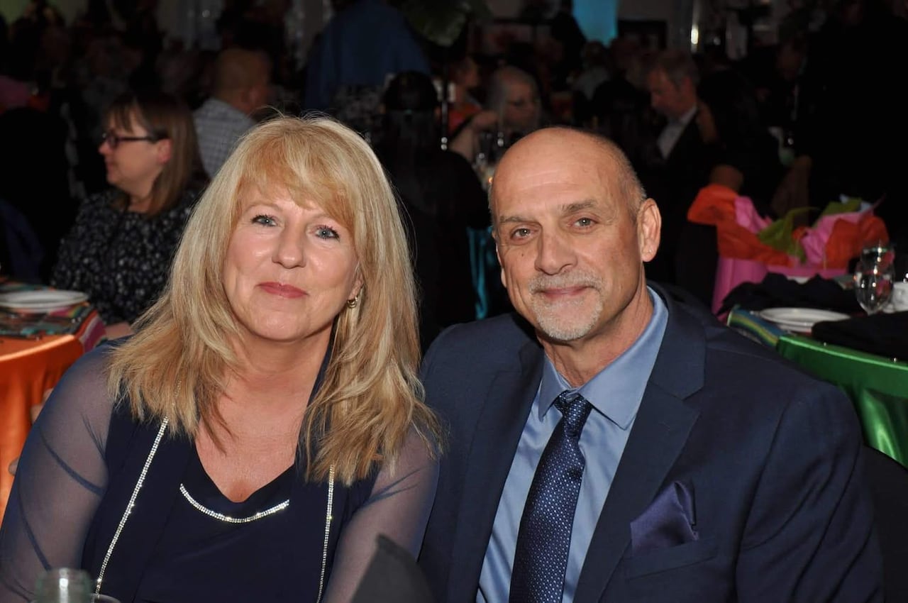 A woman and a man sit besides one another.