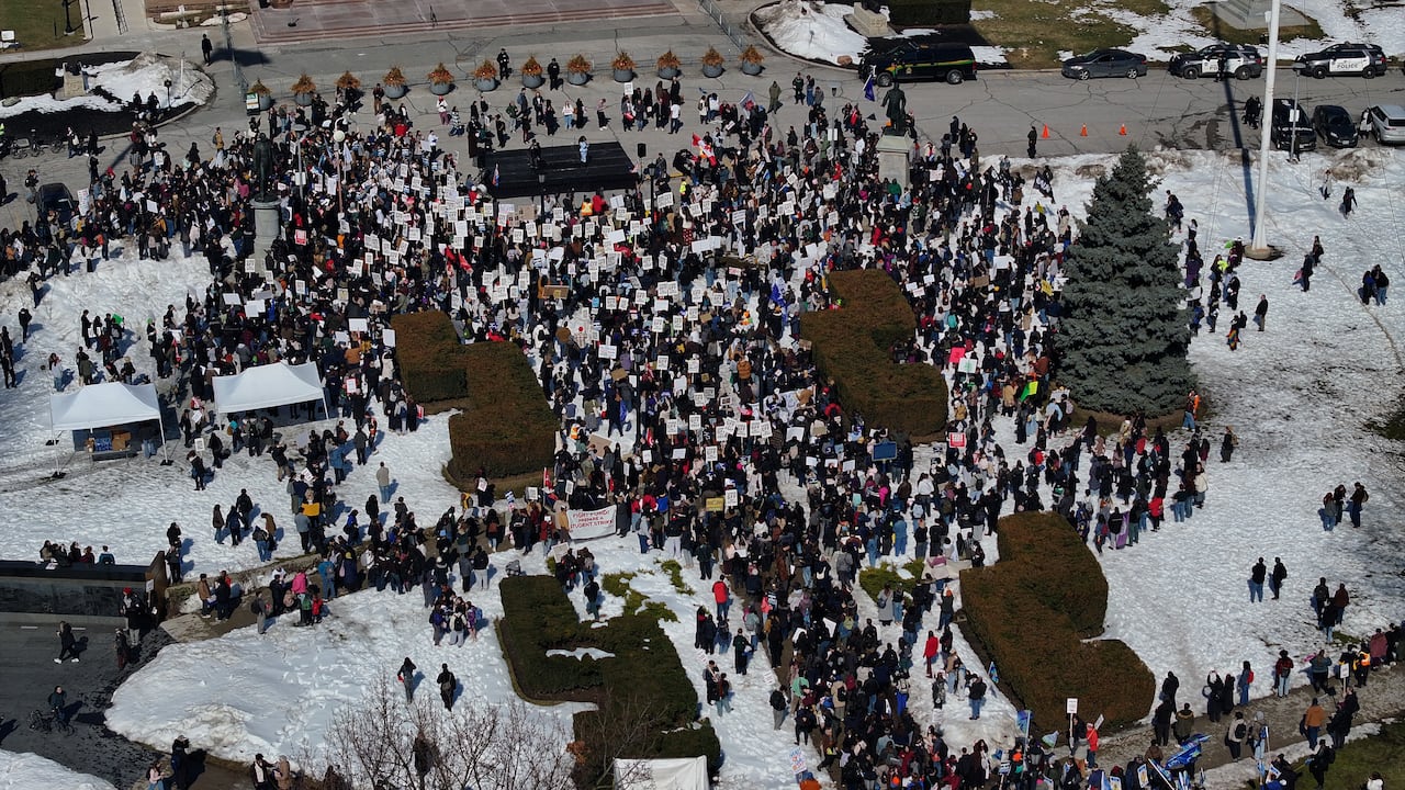 Crowd of protestors gathered outside Queen's Park. 