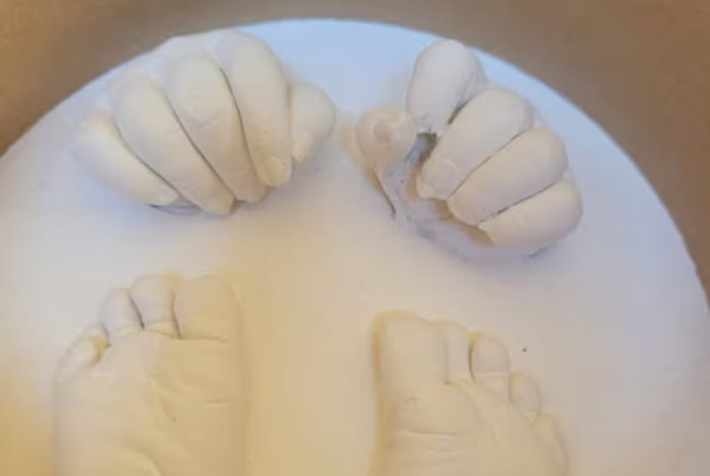 plaster cast showing two infant feet and two hands
