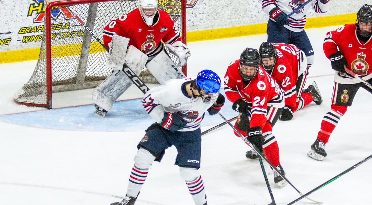 The Legionnaires, in red, try and take the puck from the opposition in front of their net in GOHL game action.