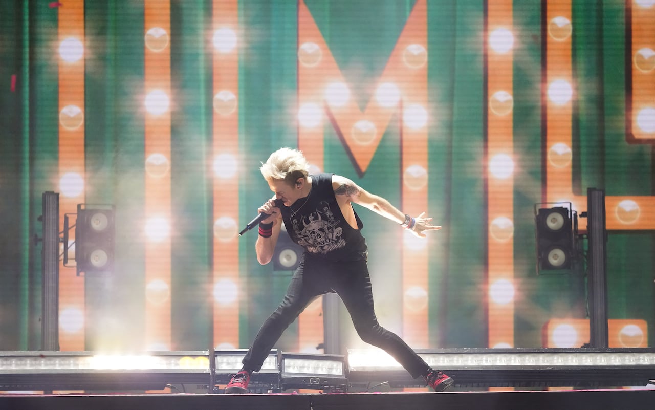 A performer on stage sings into a microphone