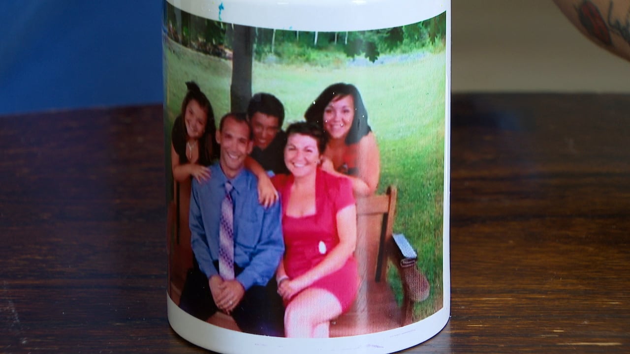 A mug shows a husband and wife, and their three children.
