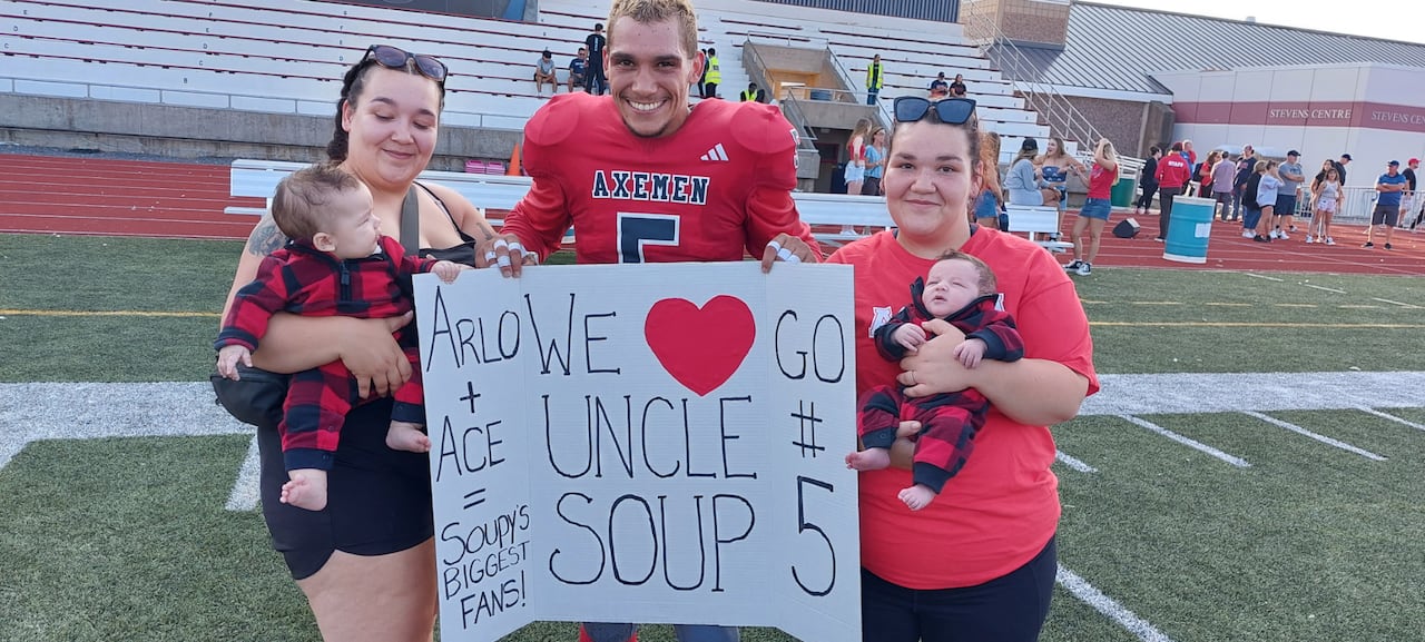 A football player is shown with four family members.