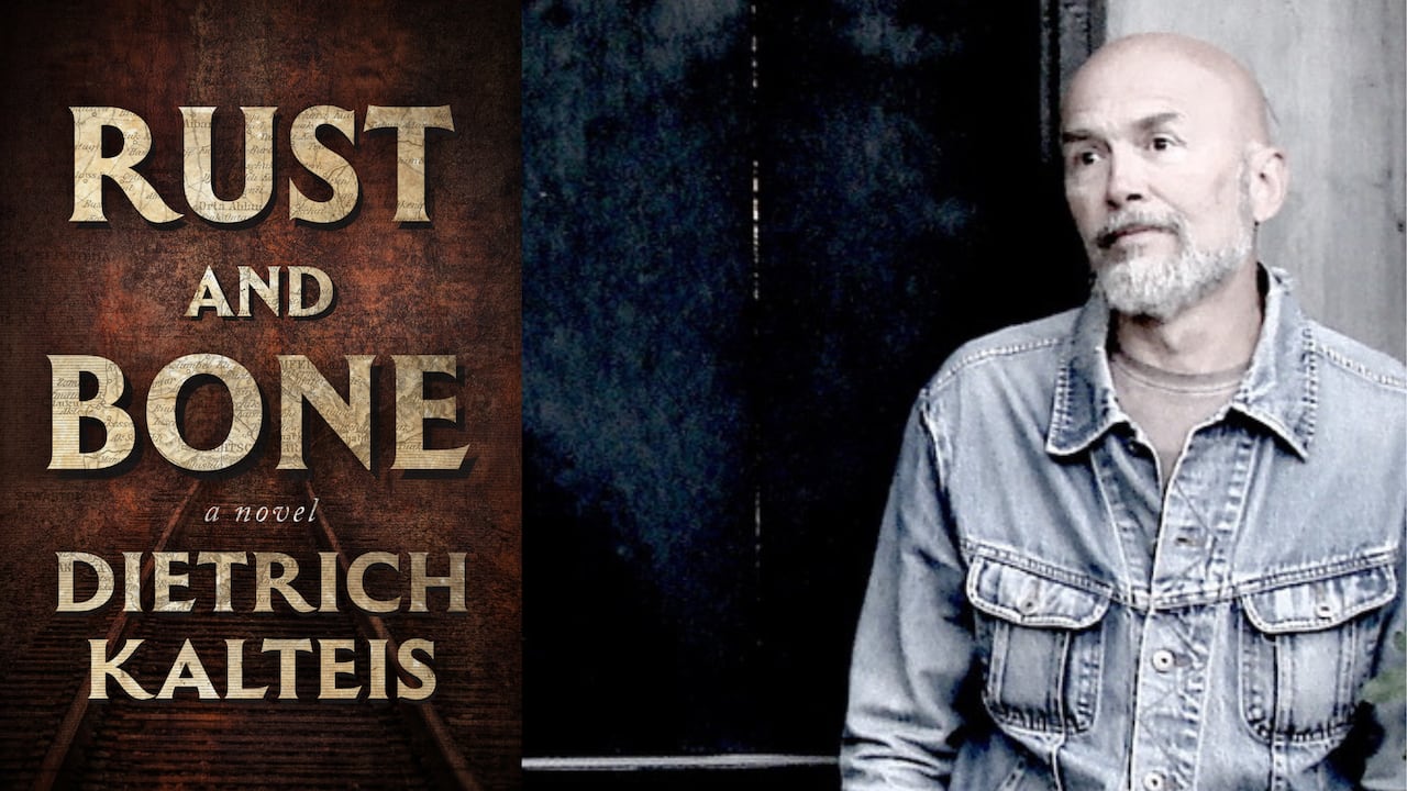 A brown book cover with a train track on it. A headshot of a bald man with a trim beard looking left. 