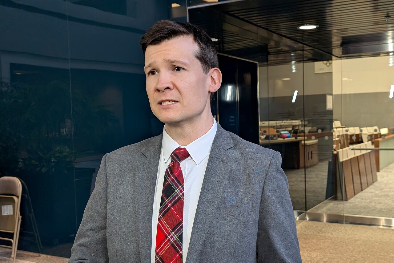 Mayor talks outside council chambers/