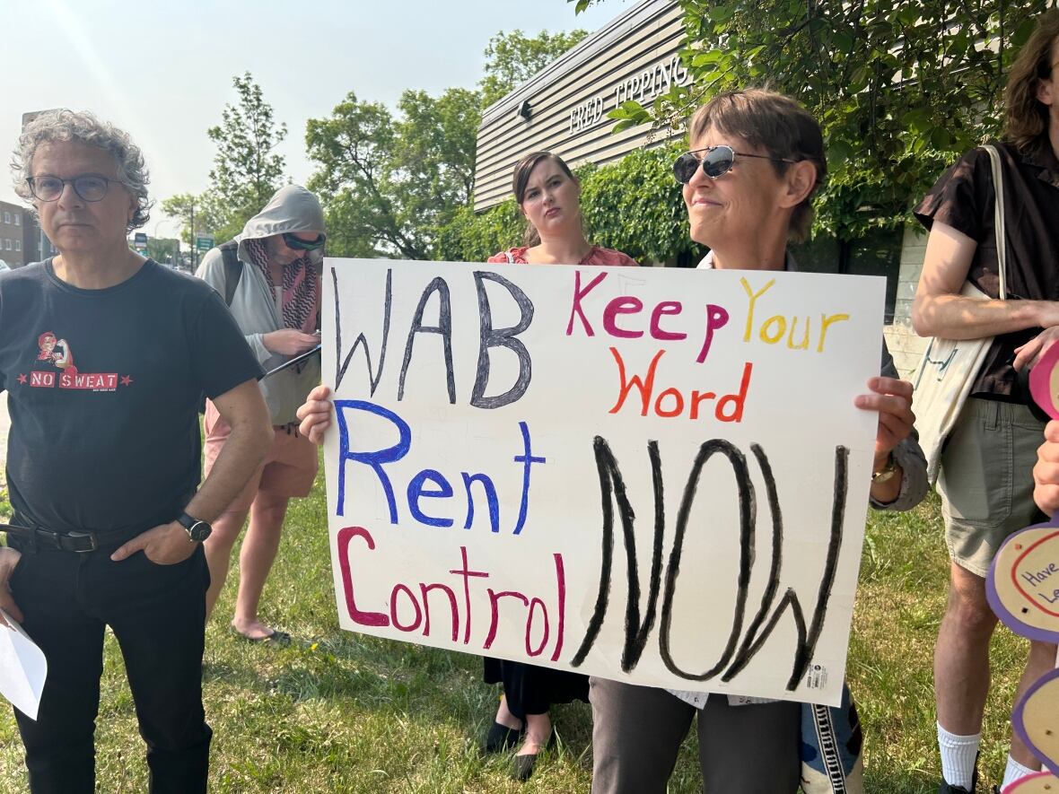 A group of people are on a field holding signs.