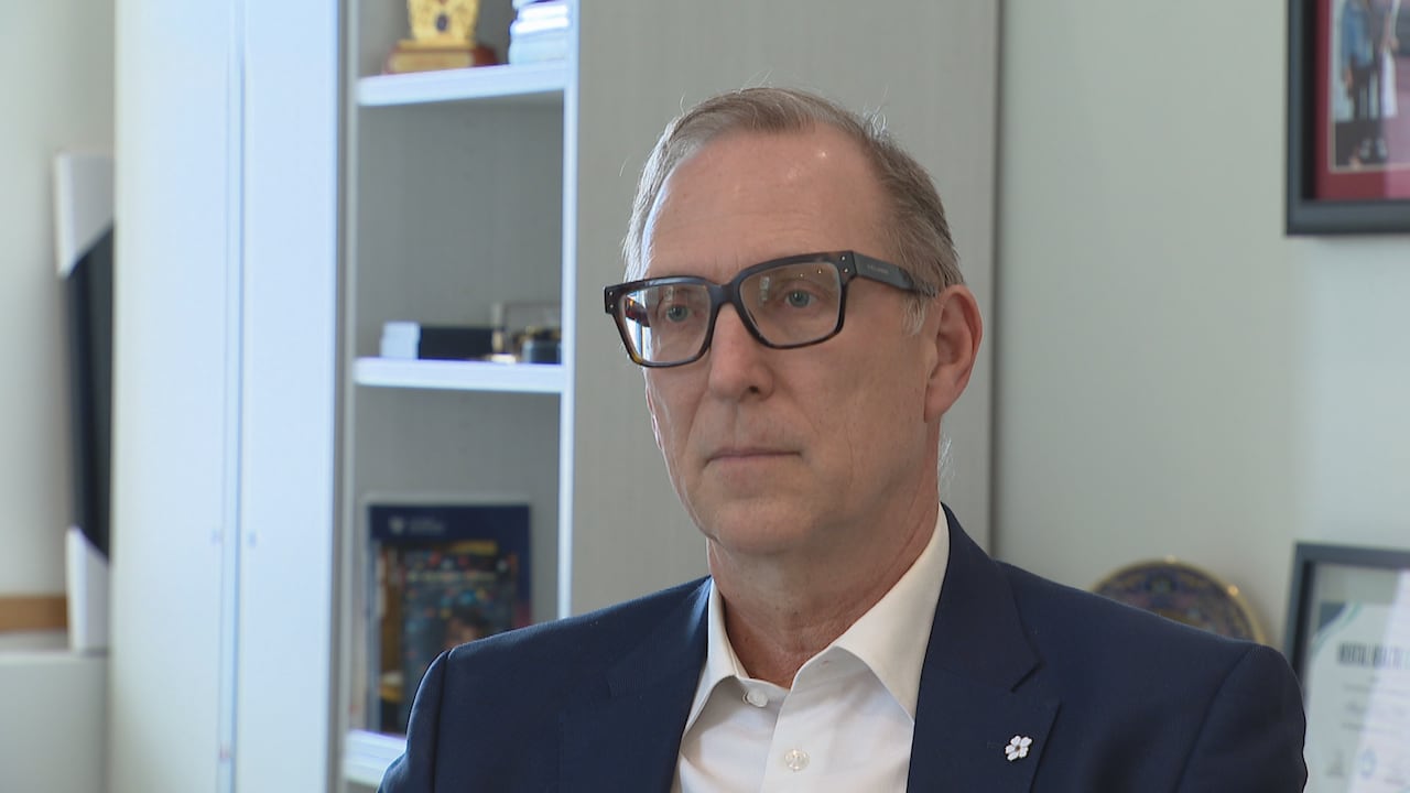 Man in a suit jacket and glasses