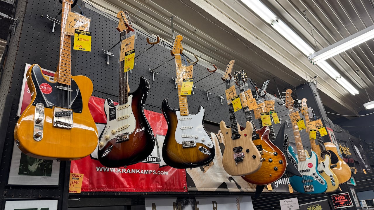 Guitars on display with sale price tags on them