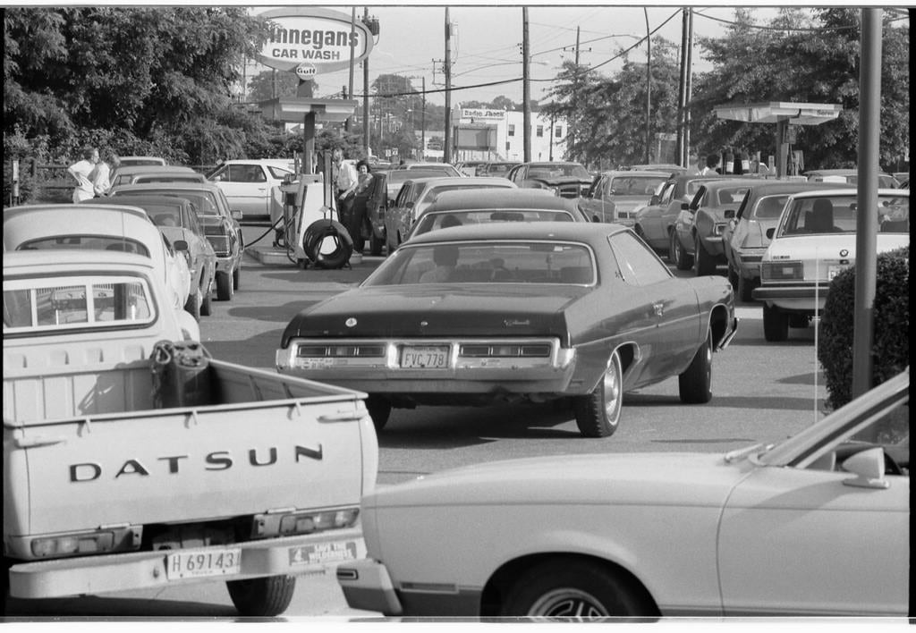 Americans wait in long lineups at a gas station waiting for fuel.