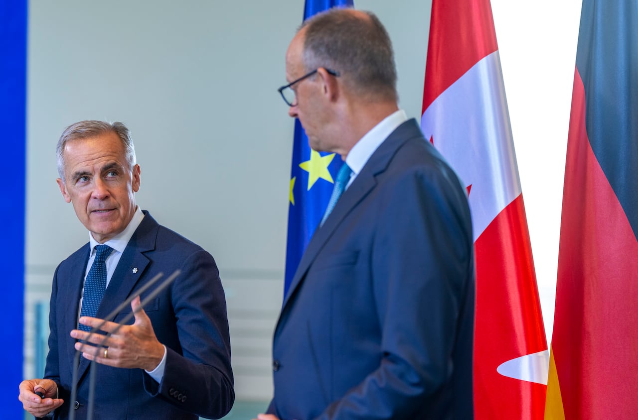 Prime Minister Mark Carney, left, announces an agreement between Torngat Metals and Vacuumschmelze in Germany in August, 2025.